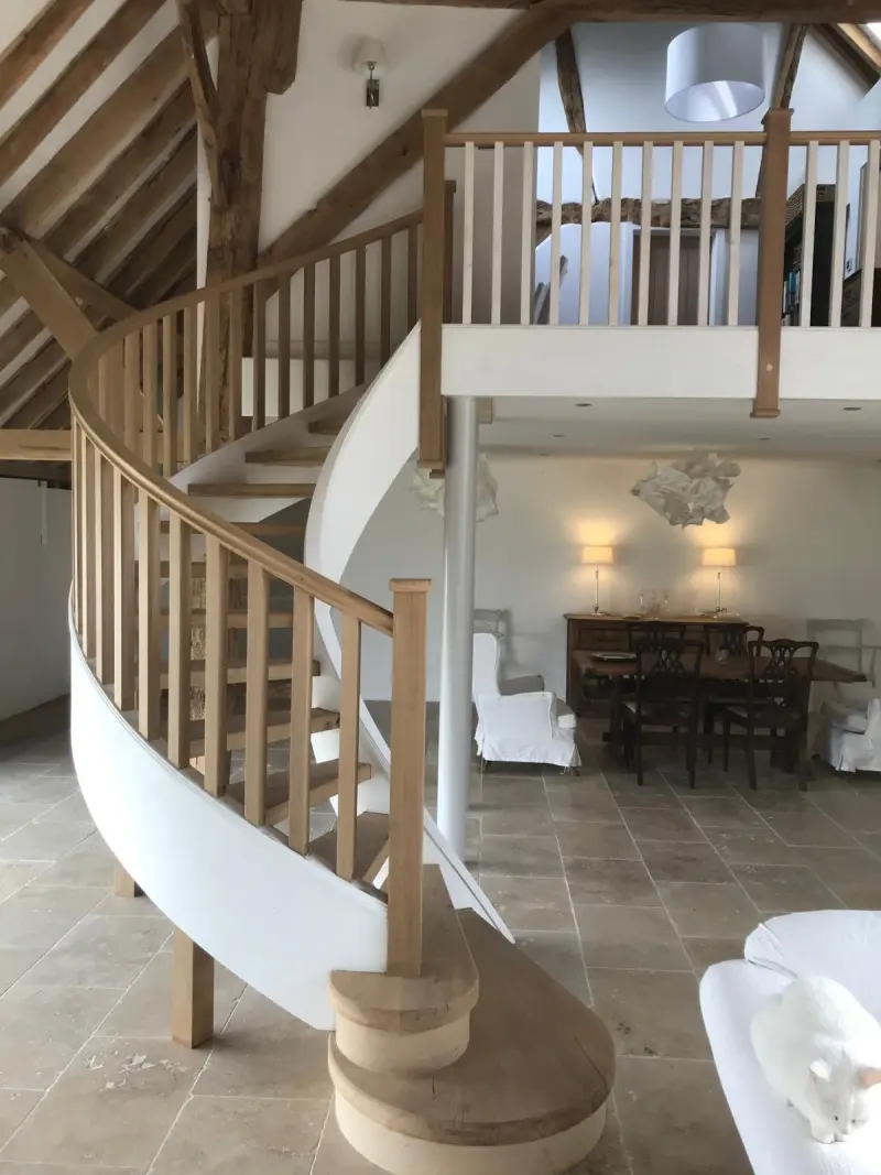 Finished curved staircase with oak balustrade