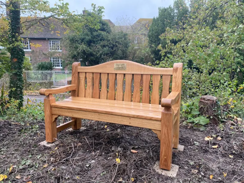 Handcrafted oak memorial bench in garden